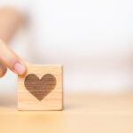 hand-holding-heart-block-for-health-care-love-or-2023-12-07-22-19-32-utc